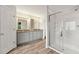 Bright bathroom features a glass-enclosed shower, a double vanity, and contemporary lighting at 7505 Brookwood Way, Cumming, GA 30041