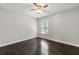 Comfortable bedroom featuring hardwood floors, ceiling fan, a window with blinds at 7505 Brookwood Way, Cumming, GA 30041
