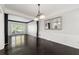 Elegant dining room featuring dark wood floors and a decorative light fixture at 7505 Brookwood Way, Cumming, GA 30041