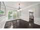 Formal dining room featuring dark wood floors, elegant trim and a large window at 7505 Brookwood Way, Cumming, GA 30041