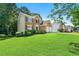Lovely two-story brick home with a green lawn and mature trees at 7505 Brookwood Way, Cumming, GA 30041