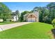 Charming brick and siding home with a spacious front yard and driveway at 7505 Brookwood Way, Cumming, GA 30041