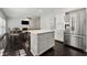 Spacious kitchen and dining area with stainless steel appliances and dark hardwood floors at 7505 Brookwood Way, Cumming, GA 30041