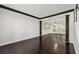 Elegant living room with dark wood floors, white walls, and large windows at 7505 Brookwood Way, Cumming, GA 30041