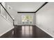 Bright living room with dark hardwood floors, white trim and large windows at 7505 Brookwood Way, Cumming, GA 30041