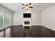 Cozy living room featuring a fireplace, neutral walls, and dark hardwood floors at 7505 Brookwood Way, Cumming, GA 30041