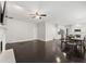 Open living space featuring kitchen, dining and fireplace with dark hardwood floors at 7505 Brookwood Way, Cumming, GA 30041