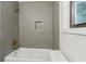 Modern bathroom featuring sleek gray tile, gold fixtures and convenient storage niche in shower at 9165 Eves Cir, Roswell, GA 30076