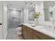 Beautiful bathroom with a glass enclosed shower, dual vanity sinks, and neutral gray tiling at 9165 Eves Cir, Roswell, GA 30076