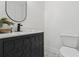 Stylish powder room featuring modern vanity, decorative mirror, and sleek fixtures at 9165 Eves Cir, Roswell, GA 30076