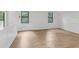 Spacious bedroom with hardwood floors, wainscoting and natural light from two windows at 9165 Eves Cir, Roswell, GA 30076