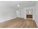 Spacious bedroom with light hardwood floors and a glimpse of the ensuite bathroom at 9165 Eves Cir, Roswell, GA 30076