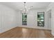 Bright dining room with wainscoting, hardwood floors, and modern chandelier at 9165 Eves Cir, Roswell, GA 30076