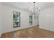 Dining room featuring hardwood floors, two windows and stylish lighting at 9165 Eves Cir, Roswell, GA 30076