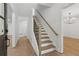 Elegant entryway with hardwood floors, staircase, and modern lighting fixtures at 9165 Eves Cir, Roswell, GA 30076