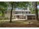 Rear view of home featuring a patio, screened in porch and a spacious backyard at 9165 Eves Cir, Roswell, GA 30076