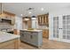 Bright kitchen with stainless appliances, hardwood floors, and a gray kitchen island at 9165 Eves Cir, Roswell, GA 30076