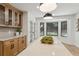 Sunlit kitchen with island and bay window offering views of the landscaped backyard at 9165 Eves Cir, Roswell, GA 30076