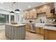 Modern kitchen featuring stainless steel appliances, gray island, and a farmhouse sink at 9165 Eves Cir, Roswell, GA 30076