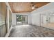 Bright sunroom with wood ceiling, tile floors, and sliding glass doors at 9165 Eves Cir, Roswell, GA 30076