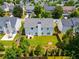 Birds-eye view of backyard shows lush green lawn, trees, privacy fence, and surrounding neighborhood at 105 Lanier Xing, Hiram, GA 30141