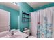 A stylish bathroom featuring a vanity, mirror, shelving, and a shower with a decorative curtain at 105 Lanier Xing, Hiram, GA 30141