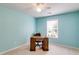 A light blue bedroom showcases a desk and chair next to a bright window at 105 Lanier Xing, Hiram, GA 30141