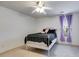 This bedroom has carpet, a ceiling fan and a window with purple curtains at 105 Lanier Xing, Hiram, GA 30141