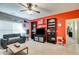 Entertaining space with shelving, a TV, and sofa illuminated by natural light at 105 Lanier Xing, Hiram, GA 30141