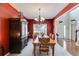 Spacious dining room with a large table, red walls, and access to the foyer and living areas at 105 Lanier Xing, Hiram, GA 30141