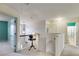 Upstairs hallway with staircase, pendant lighting and doors to bedrooms and bathrooms at 105 Lanier Xing, Hiram, GA 30141