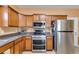 Well-lit kitchen showcasing stainless steel appliances and wood cabinetry at 105 Lanier Xing, Hiram, GA 30141