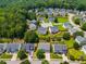 Aerial view of neighborhood, surrounded by mature trees, highlighting a Gathering-friendly community at 105 Lanier Xing, Hiram, GA 30141
