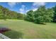 Spacious backyard with mature trees surrounding the lush lawn at 172 Lakeview Dr, Newborn, GA 30056