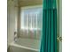 Bathroom with a combination shower and tub, tile surround, and neutral-colored curtain at 172 Lakeview Dr, Newborn, GA 30056