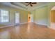 Large primary bedroom with ceiling fan, wood flooring, and access to ensuite bathroom and porch at 172 Lakeview Dr, Newborn, GA 30056