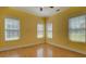 Bright bedroom features wood-look floors, multiple windows, a ceiling fan, and neutral trim at 172 Lakeview Dr, Newborn, GA 30056