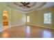 Large primary bedroom featuring wood floors, tray ceiling, ceiling fan, and ensuite bathroom at 172 Lakeview Dr, Newborn, GA 30056