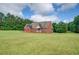 Charming brick home with a large, lush green lawn surrounded by mature trees at 172 Lakeview Dr, Newborn, GA 30056