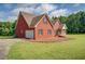 Side view of a brick house with an attached garage and well-maintained lawn at 172 Lakeview Dr, Newborn, GA 30056