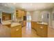 Open-concept kitchen with stainless steel appliances, wooden cabinets, and hardwood flooring at 172 Lakeview Dr, Newborn, GA 30056