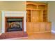 Living room with brick fireplace and wooden built-in shelves with cabinets below at 172 Lakeview Dr, Newborn, GA 30056