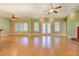 Bright and airy living room with hardwood floors, ceiling fans, and double doors to the backyard at 172 Lakeview Dr, Newborn, GA 30056