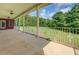 Covered back patio with decorative railing overlooking a grassy backyard at 172 Lakeview Dr, Newborn, GA 30056