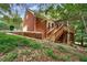Brick house showing the side and back of the property with a two-car garage and backyard deck at 2935 Abbottswell Dr, Alpharetta, GA 30022