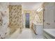 Bathroom with floral wallpaper, a soaking tub, and a vanity with double sinks at 2935 Abbottswell Dr, Alpharetta, GA 30022