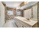 Well-maintained bathroom with dual sinks, floral wallpaper, and ample countertop space, offering comfort and style at 2935 Abbottswell Dr, Alpharetta, GA 30022