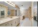 Spacious bathroom features dual sinks, ample counter space, and classic floral wallpaper, creating a welcoming space at 2935 Abbottswell Dr, Alpharetta, GA 30022