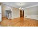 Formal dining room featuring gleaming hardwood floors and crown molding at 2935 Abbottswell Dr, Alpharetta, GA 30022