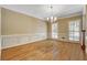 Formal dining room with hardwood floors and natural light from plantation shutters at 2935 Abbottswell Dr, Alpharetta, GA 30022